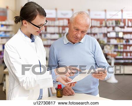 Stock Photo - Pharmacist talking to patient in store. Fotosearch
