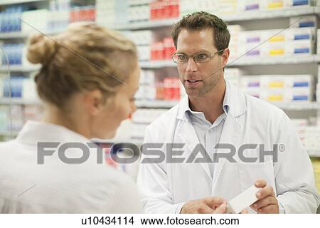 Picture - Pharmacist teaching patient about drug. Fotosearch