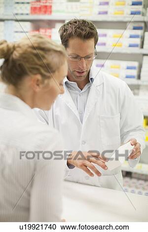 Pharmacist teaching patient about drug View Large Photo Image Stock Image - Pharmacist teaching patient about drug. Fotosearch