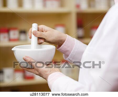 Pharmacist using mortar and pestle View Large Photo Image Stock Photo - Pharmacist using mortar and pestle. Fotosearch