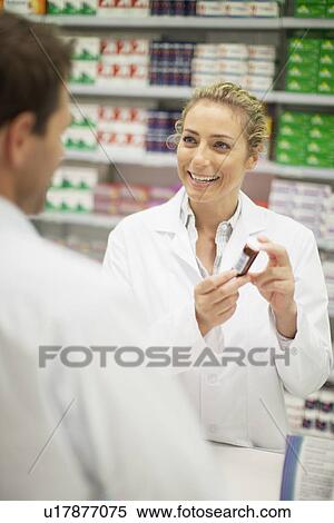 Stock Photography - Pharmacists discussing medication. Fotosearch
