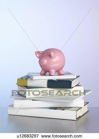 Piggy bank on stack of books View Large Photo Image Stock Photo - Piggy bank on stack of books. Fotosearch
