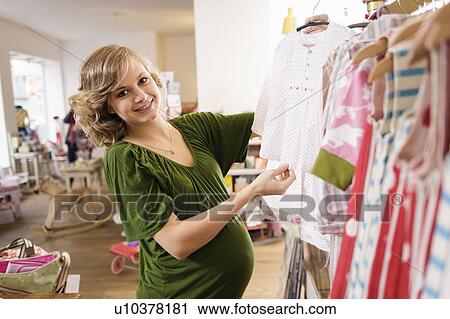 Pregnant woman buying baby clothes View Large Photo Image Stock Image - Pregnant woman buying baby clothes. Fotosearch