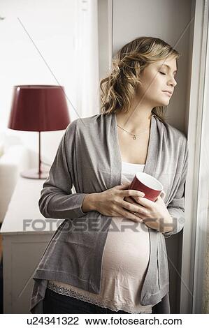 Pregnant woman having cup of coffee View Large Photo Image Stock Image - Pregnant woman having cup of coffee. Fotosearch