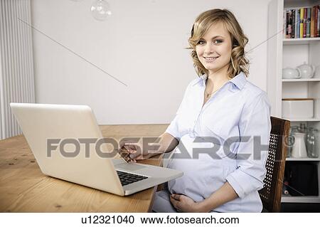 Pregnant woman shopping online View Large Photo Image Stock Image - Pregnant woman shopping online. Fotosearch