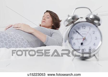 Pregnant woman sleeping on bed View Large Photo Image Stock Image - Pregnant woman sleeping on bed. Fotosearch