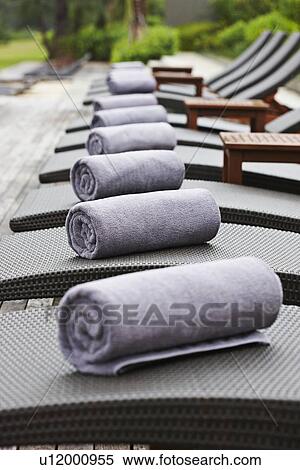 Rolled towels on lawn chairs outdoors View Large Photo Image Stock Photography - Rolled towels on lawn chairs outdoors. Fotosearch