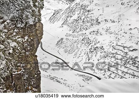 Stock Photo - Rural road in snowy mountains. Fotosearch