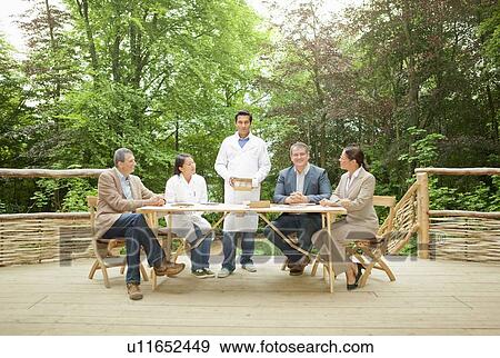 Stock Photo - Scientist talking in meeting. Fotosearch