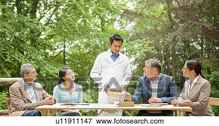 Scientist talking in meeting View Large Photo Image Stock Photo - Scientist talking in meeting. Fotosearch