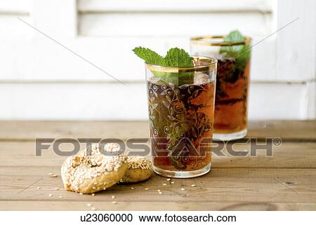 Stock Image - Sesame pastry and tea on table. Fotosearch