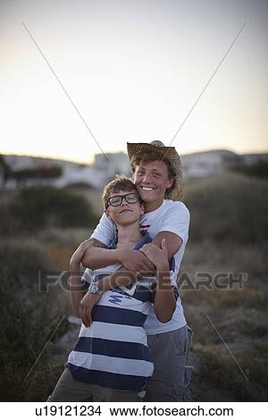 Smiling brothers hugging outdoors View Large Photo Image Picture - Smiling brothers hugging outdoors. Fotosearch