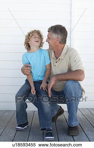 Stock Photography - Smiling father and son on deck. Fotosearch