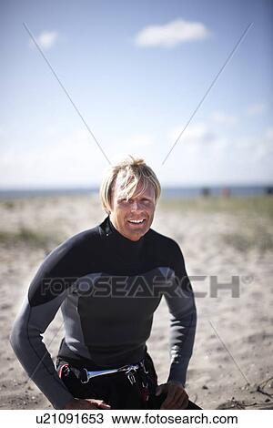 Smiling man resting on beach View Large Photo Image Stock Image - Smiling man resting on beach. Fotosearch