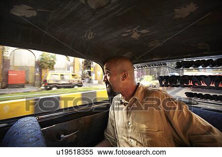 Stock Photography - Smiling man riding in taxi cab. Fotosearch