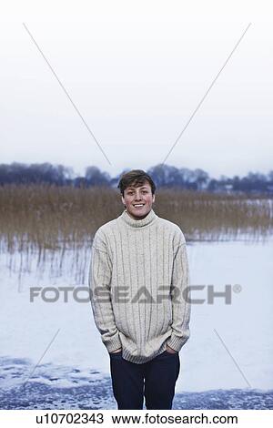 Smiling man standing in snow View Large Photo Image Stock Image - Smiling man standing in snow. Fotosearch