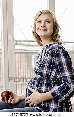 Smiling pregnant woman eating apple View Large Photo Image Stock Image - Smiling pregnant woman eating apple. Fotosearch