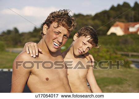 Stock Photo - Smiling teenage boys relaxing outdoors. Fotosearch