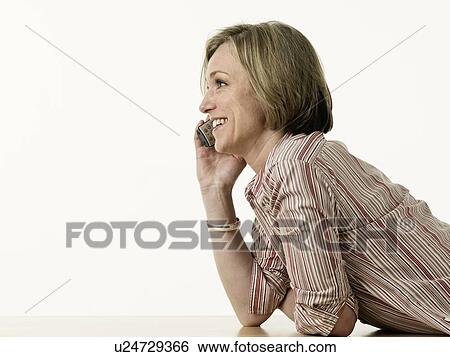 Smiling woman talking on telephone View Large Photo Image Stock Photograph - Smiling woman talking on telephone. Fotosearch