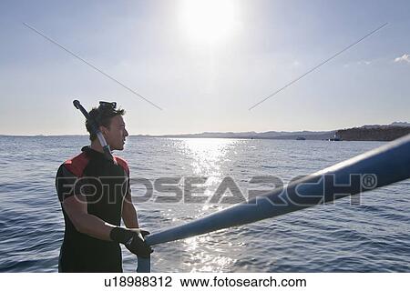 Snorkeler climbing steps from water View Large Photo Image Stock Image - Snorkeler climbing steps from water. Fotosearch