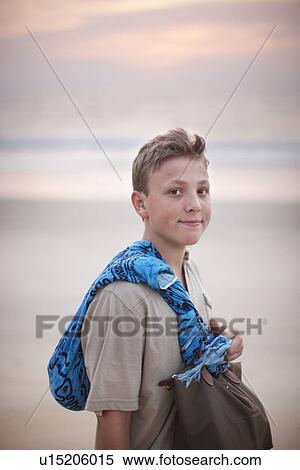 Teenage boy carrying scarf and purse View Large Photo Image Stock Photography - Teenage boy carrying scarf and purse. Fotosearch