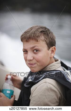 Teenage boy drinking from water bottle View Large Photo Image Stock Photography - Teenage boy drinking from water bottle. Fotosearch