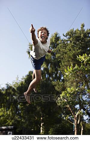 Teenage boy pointing in mid-air View Large Photo Image Stock Image - Teenage boy pointing in mid-air. Fotosearch