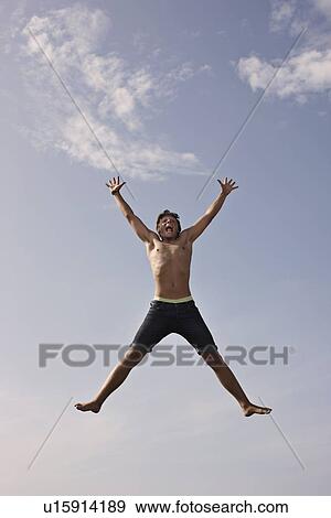 Teenage boy posing in mid-air View Large Photo Image Stock Photo - Teenage boy posing in mid-air. Fotosearch