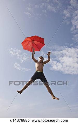 Stock Photography - Teenage boy posing in mid-air. Fotosearch