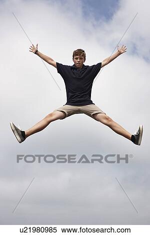 Teenage boy posing in mid-air View Large Photo Image Stock Photography - Teenage boy posing in mid-air. Fotosearch