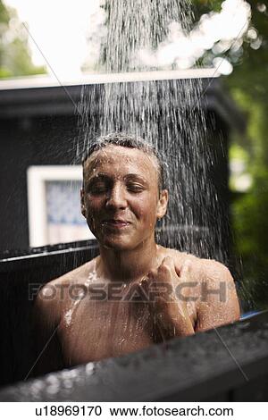 Teenage boy showering outdoors View Large Photo Image Stock Image - Teenage boy showering outdoors. Fotosearch