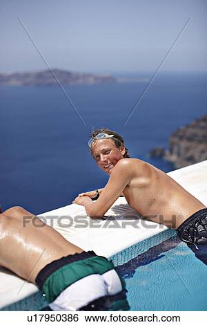 Teenage boys relaxing in infinity pool View Large Photo Image Stock Photograph - Teenage boys relaxing in infinity pool. Fotosearch