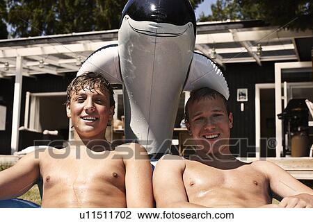 Teenage boys relaxing together outdoors View Large Photo Image Stock Image - Teenage boys relaxing together outdoors. Fotosearch