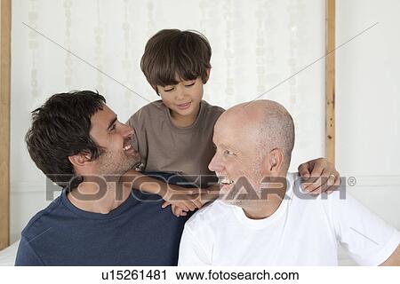 Three generations of men on bed View Large Photo Image Stock Image - Three generations of men on bed. Fotosearch