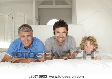 Three generations of men on bed View Large Photo Image Stock Image - Three generations of men on bed. Fotosearch