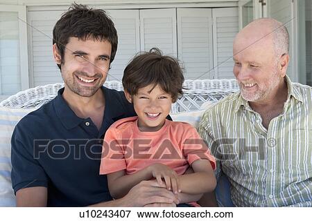 Three generations of men on sofa View Large Photo Image Stock Photo - Three generations of men on sofa. Fotosearch