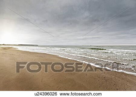 Waves washing up on beach View Large Photo Image Stock Photograph - Waves washing up on beach. Fotosearch