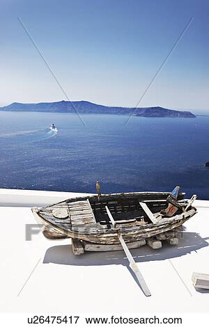 Stock Photo - Weathered wooden boat on balcony. Fotosearch