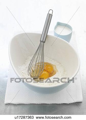 Whisk in bowl with eggs and flour View Large Photo Image Stock Image - Whisk in bowl with eggs and flour. Fotosearch