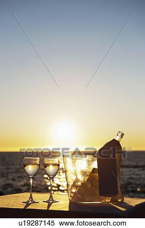 Stock Photography - Wine glasses and bottle outdoors. Fotosearch