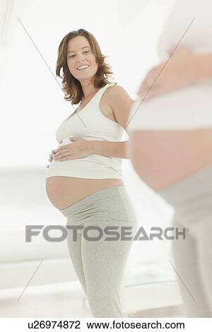 Woman admiring pregnant belly View Large Photo Image Stock Image - Woman admiring pregnant belly. Fotosearch