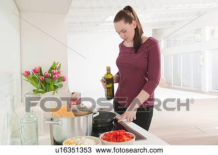 Woman cooking in kitchen View Large Photo Image Stock Image - Woman cooking in kitchen. Fotosearch