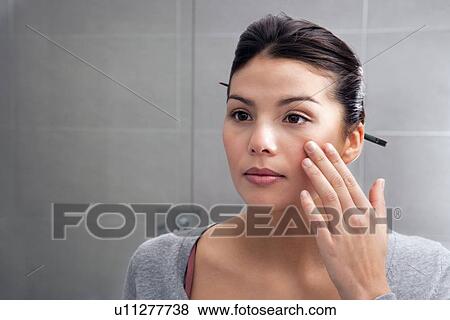 Woman examining herself in mirror View Large Photo Image Stock Photo - Woman examining herself in mirror. Fotosearch