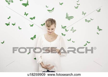Woman holding pregnant belly View Large Photo Image Stock Photo - Woman holding pregnant belly. Fotosearch