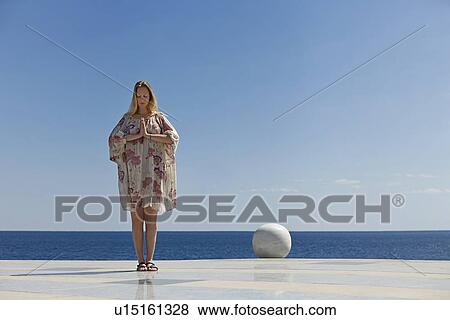 Woman meditating on tiled surface View Large Photo Image Stock Photo - Woman meditating on tiled surface. Fotosearch