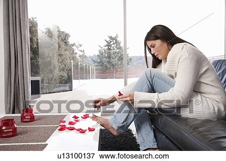Woman painting toenails in living room View Large Photo Image Stock Photo - Woman painting toenails in living room. Fotosearch