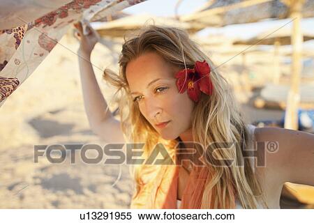 Stock Photography - Woman playing with fabric on beach. Fotosearch