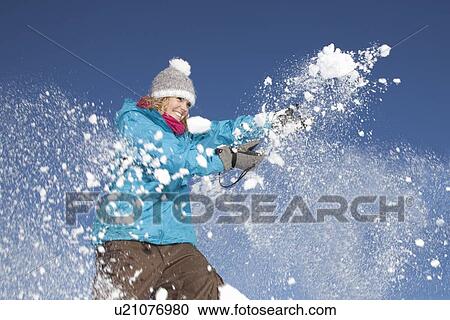 Woman playing with snow outdoors View Large Photo Image Stock Image - Woman playing with snow outdoors. Fotosearch