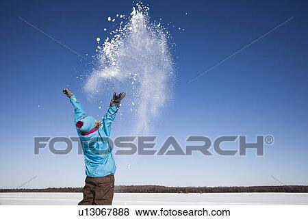 Woman playing with snow outdoors View Large Photo Image Stock Photo - Woman playing with snow outdoors. Fotosearch