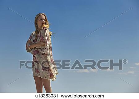 Woman standing outdoors View Large Photo Image Stock Image - Woman standing outdoors. Fotosearch